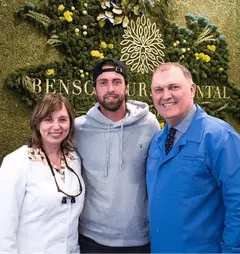 Tennis player Nikoloz Basilashvili posing with the team at Bensonhurst Dental Care